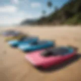 A vibrant collection of affordable boogie boards displayed on a sandy beach