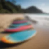 Different sizes of skimboards lined up on the beach