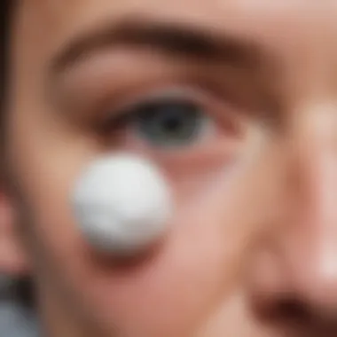 Using Cotton Ball with Oil for Ear Care A cotton ball with oil to aid ear cleaning