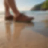 Stunning view of Olukai Hokua shoes on a sandy beach