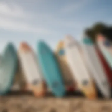 A close-up of surfboards lined up on the sandy beach, ready for action.