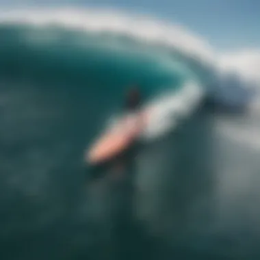 An aerial shot of surfers riding waves on hard top surfboards in a vibrant ocean setting.