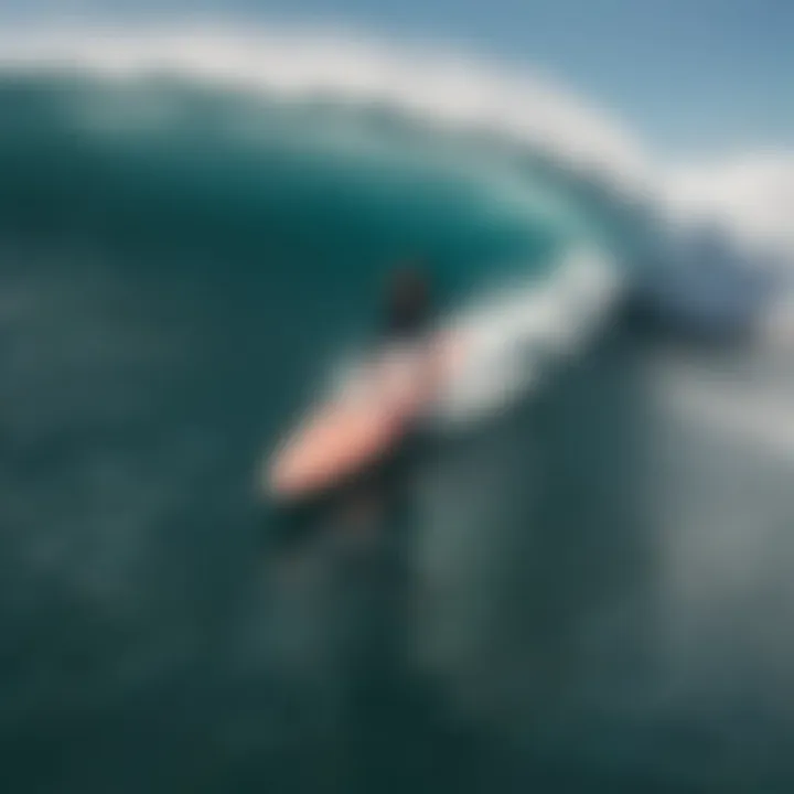 An aerial shot of surfers riding waves on hard top surfboards in a vibrant ocean setting.