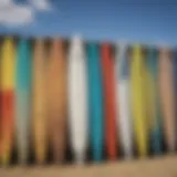 A colorful array of used surfboards displayed on the beach