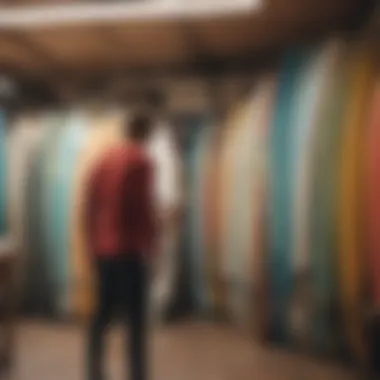 A surfer examining a used surfboard in a local shop