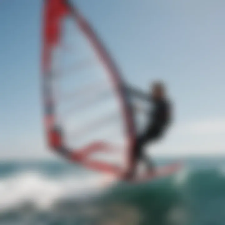 A dynamic scene of a windsurfer navigating the waves with a high-performance sail