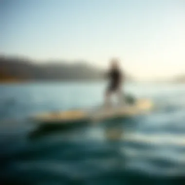 Performance in Action: Laird SUP Board A paddler gliding smoothly on a Laird SUP board on serene waters