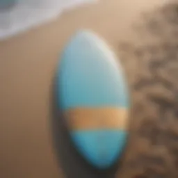 A sleek six-foot surfboard resting on a sandy beach under a clear blue sky