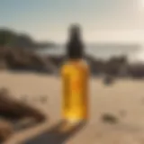 Close-up of Sun Bum Oil Mist bottle against a beach backdrop