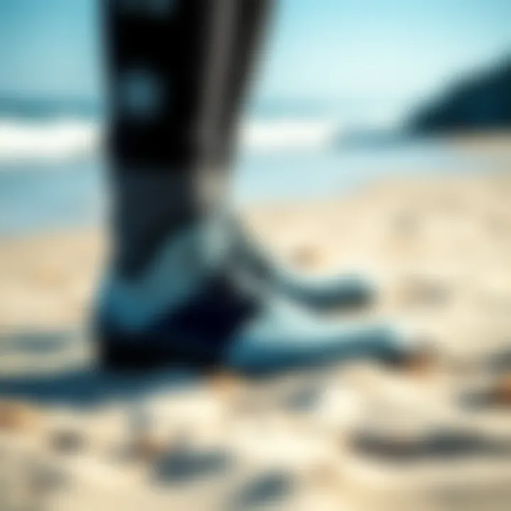 Close-up of high-performance surfing boots on a sandy beach