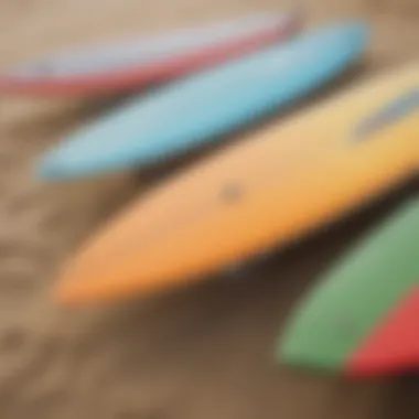 A close-up of surfboards lined up on the sandy beach, ready for action.