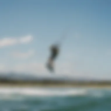 A scenic view of a kiteboarding session on a sunny day