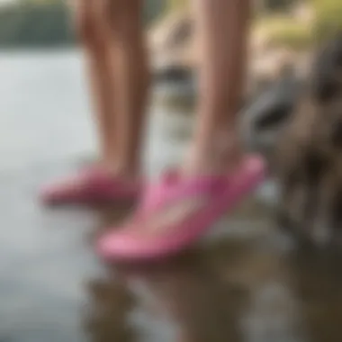 Pink Sanuk flip flops paired with watersport gear