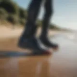 A pair of stylish wetsuit boots on a sandy beach